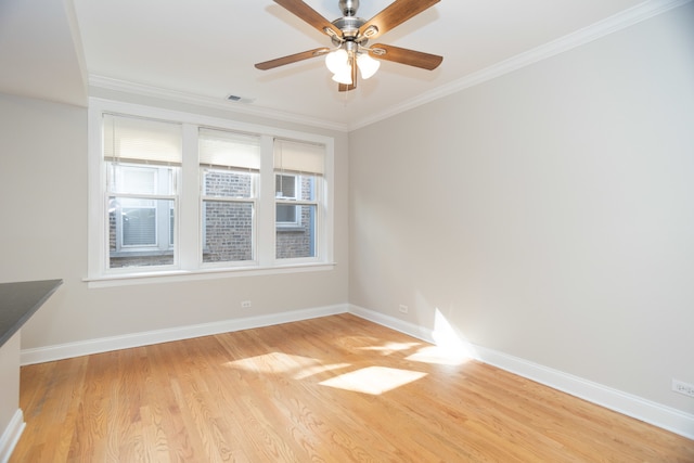 empty room with light hardwood / wood-style floors, crown molding, and ceiling fan