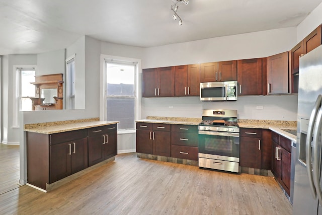 kitchen with light wood-type flooring and appliances with stainless steel finishes