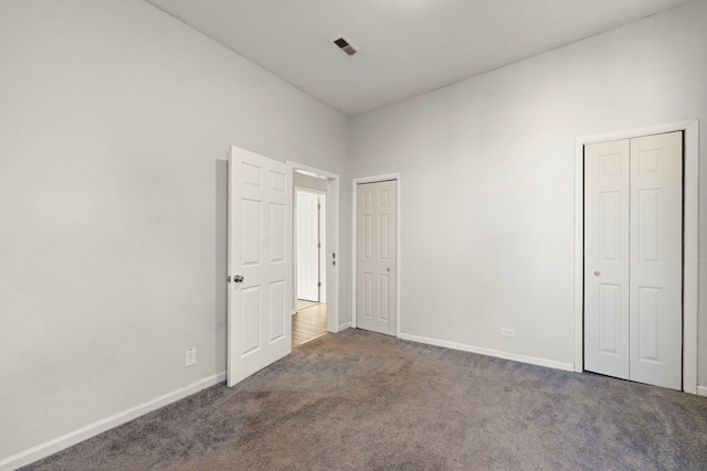 unfurnished bedroom featuring dark colored carpet