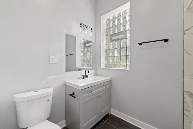 bathroom with tile patterned flooring, vanity, and toilet