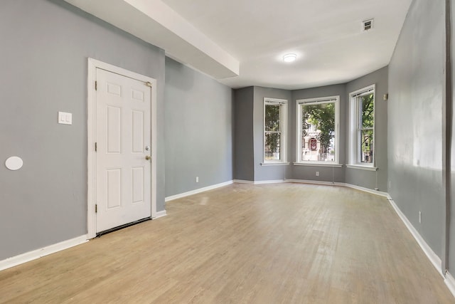 empty room with light hardwood / wood-style flooring