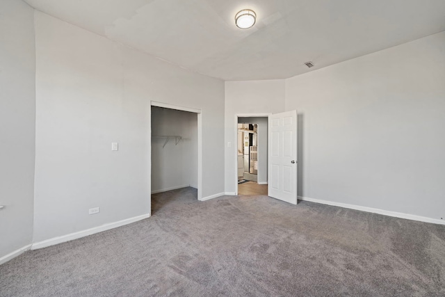 unfurnished bedroom featuring a closet and carpet floors