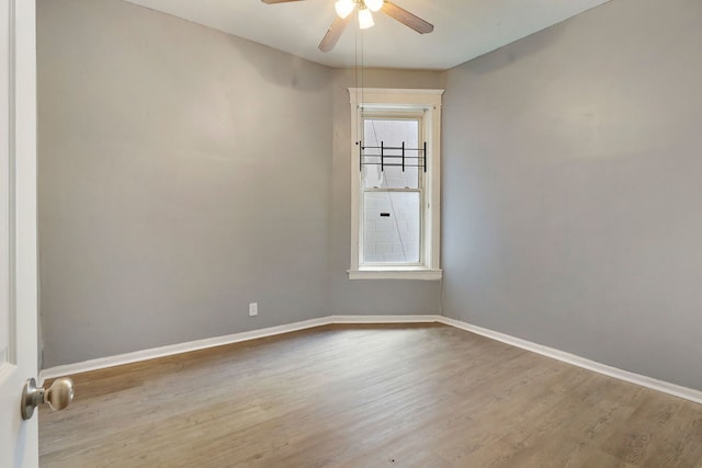 empty room featuring light hardwood / wood-style flooring and ceiling fan