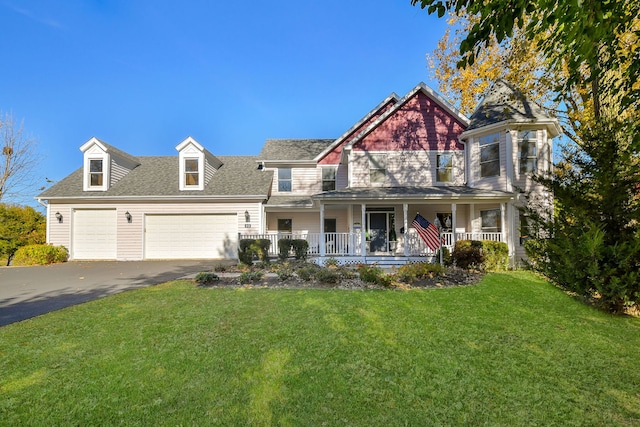 view of front of house with a garage, a porch, and a front lawn