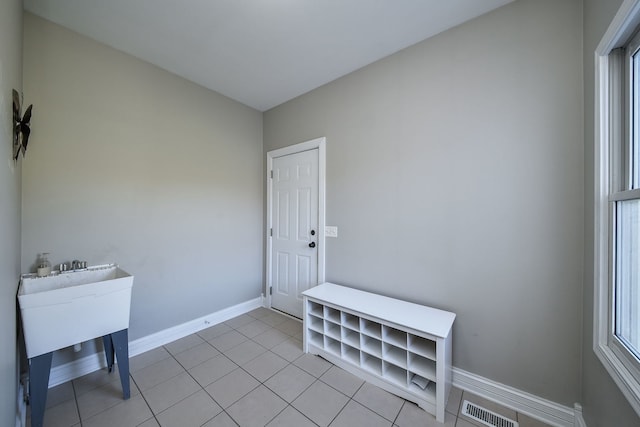 interior space featuring a healthy amount of sunlight and light tile patterned floors