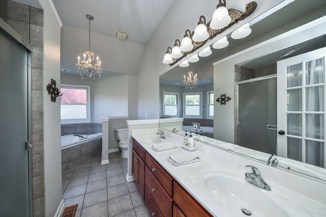 full bathroom with a wealth of natural light, tile patterned flooring, toilet, and separate shower and tub