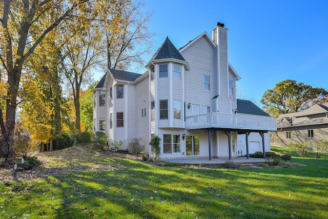 back of property featuring a lawn and a patio area