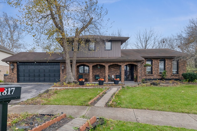 view of front facade featuring covered porch, a garage, and a front yard