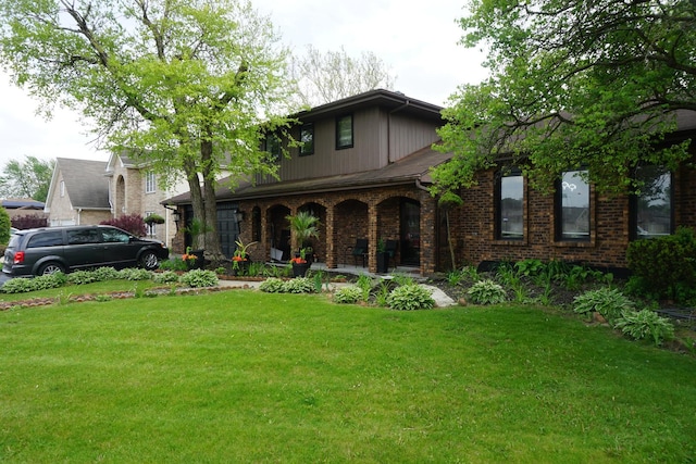 1817 E 171st Pl, South Holland, IL 60473 - traditional home featuring covered porch, a front lawn, and brick siding