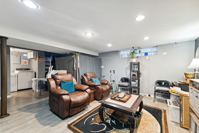 living room featuring separate washer and dryer and hardwood / wood-style flooring