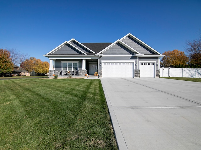 craftsman inspired home with a front yard and a garage