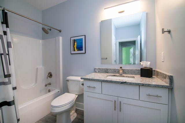 full bathroom with vanity, hardwood / wood-style floors, shower / bath combination with curtain, and toilet