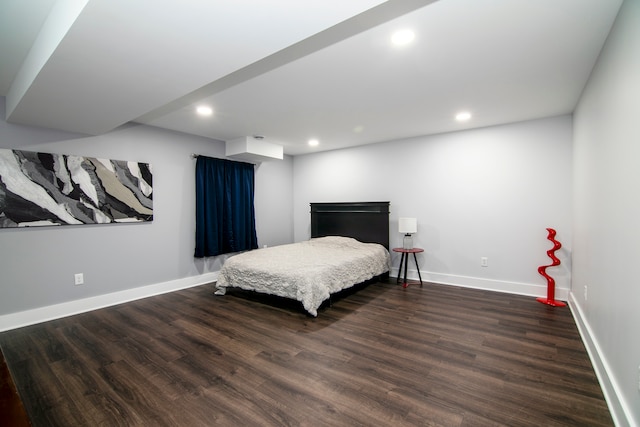 bedroom with dark hardwood / wood-style floors