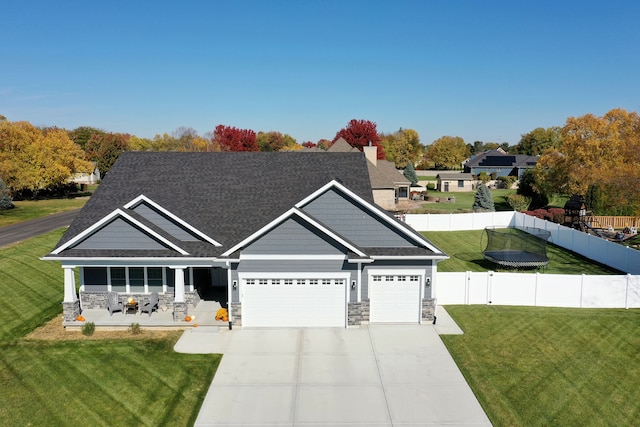 craftsman inspired home featuring a front lawn and a garage