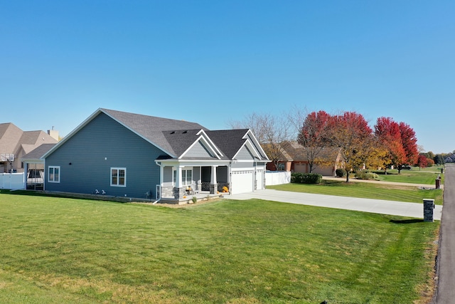 view of front of house with a front yard and a garage