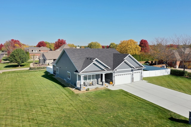 view of front of house featuring a garage, a front lawn, and a porch