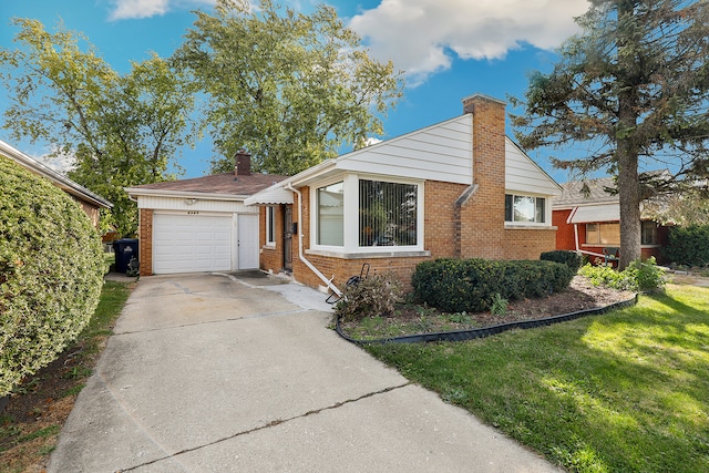 view of front of property with a front yard and a garage