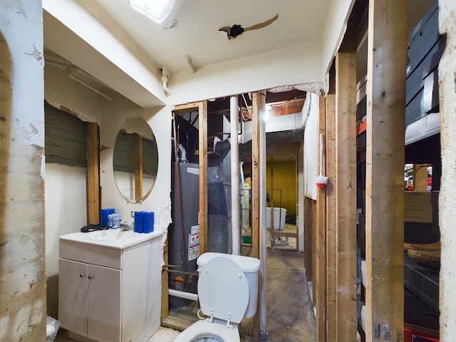 bathroom featuring vanity, gas water heater, and toilet