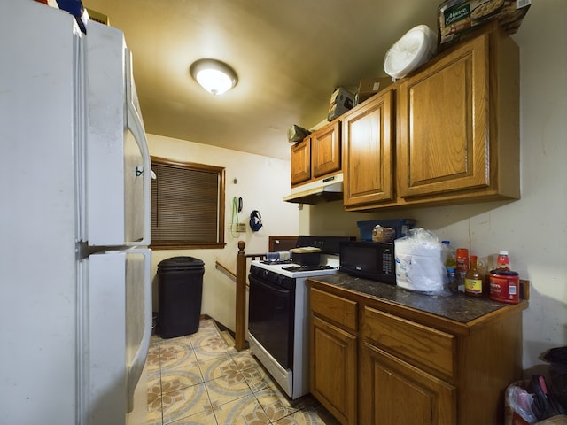 kitchen featuring white appliances and light tile patterned floors