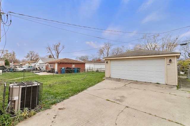 garage featuring central air condition unit and a yard