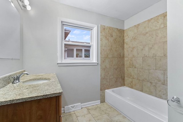 bathroom featuring tile patterned floors, vanity, and tiled shower / bath combo