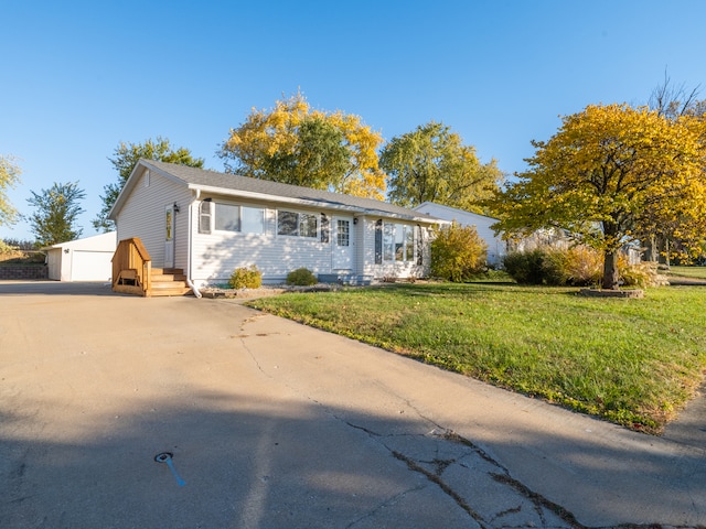 ranch-style home with a garage and a front lawn