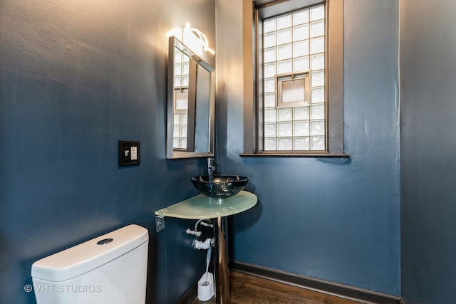 bathroom with toilet, hardwood / wood-style flooring, sink, and plenty of natural light