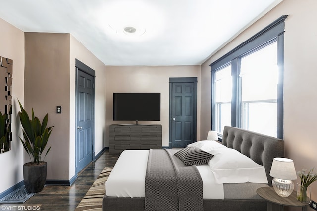 bedroom with dark wood-type flooring