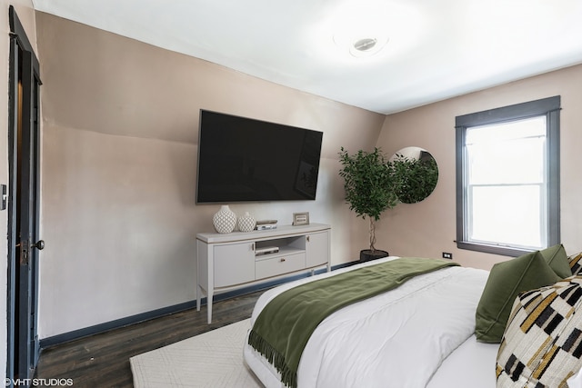 bedroom with dark hardwood / wood-style flooring and vaulted ceiling