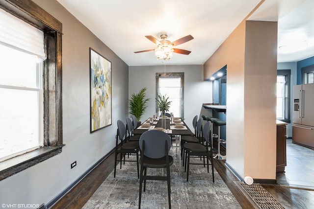 dining space with dark hardwood / wood-style floors and ceiling fan