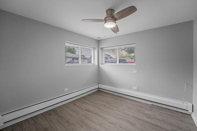 spare room featuring ceiling fan, a baseboard radiator, and light wood-type flooring