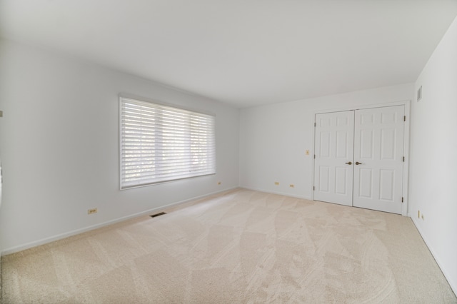 empty room featuring light colored carpet