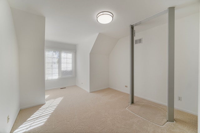 additional living space featuring light colored carpet