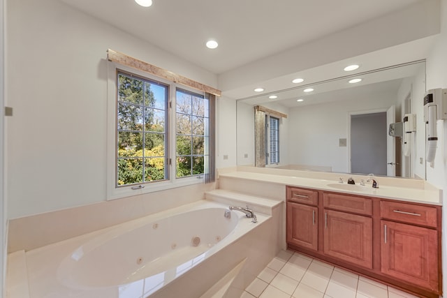 bathroom featuring vanity, tile patterned floors, and a washtub