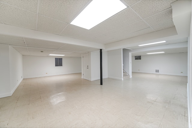 basement featuring a paneled ceiling