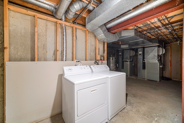 clothes washing area with gas water heater, washing machine and dryer, and heating unit