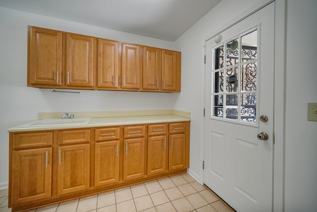 kitchen featuring sink and light tile patterned floors