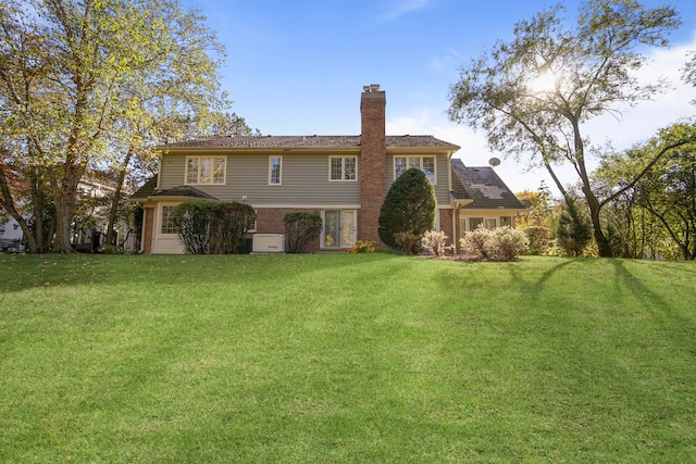 rear view of house with a yard