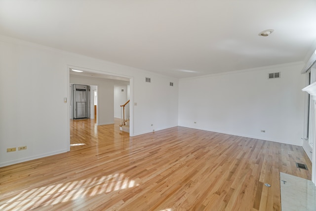 unfurnished living room with crown molding and light hardwood / wood-style flooring