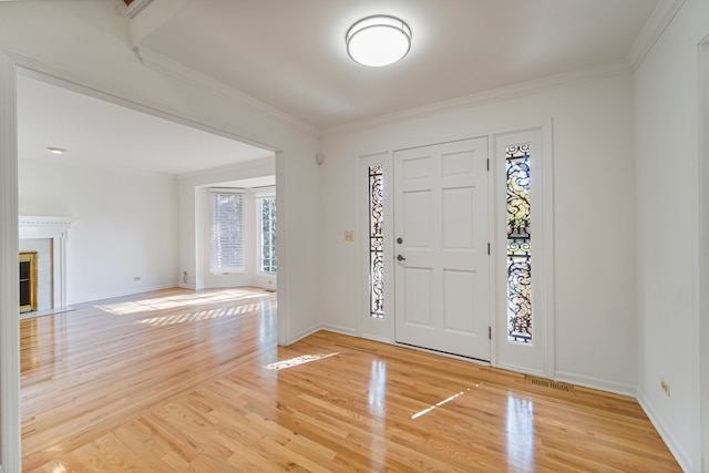 entrance foyer with ornamental molding and wood-type flooring