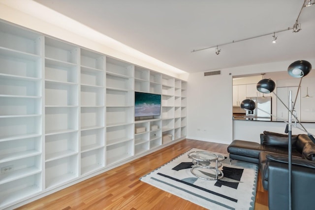 living room featuring hardwood / wood-style flooring and rail lighting