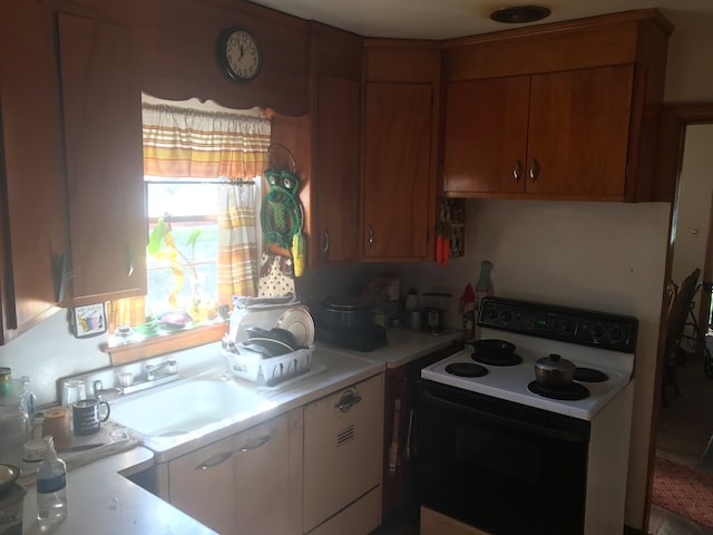 kitchen featuring sink and white range with electric cooktop