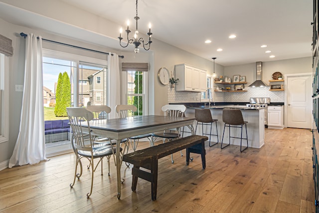 dining room featuring a chandelier and light wood-type flooring