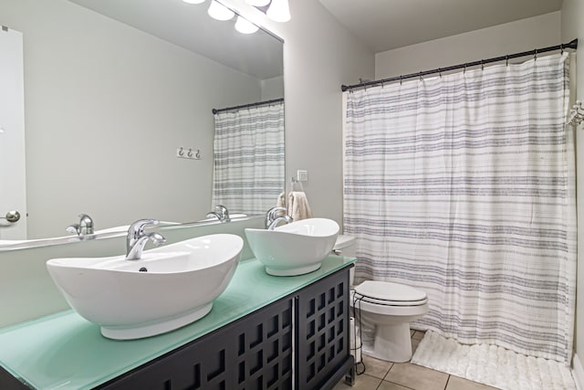 bathroom featuring vanity, toilet, tile patterned flooring, and a shower with shower curtain