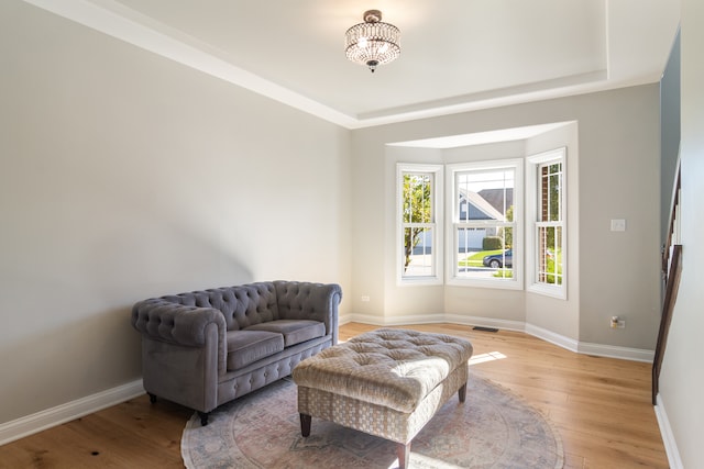 sitting room featuring light hardwood / wood-style floors and a notable chandelier