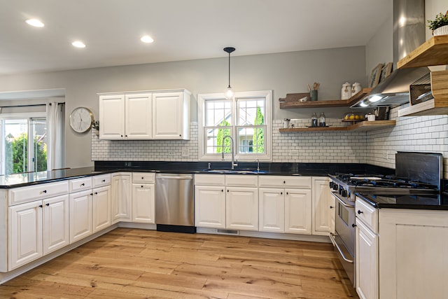 kitchen with light hardwood / wood-style floors, white cabinetry, stainless steel appliances, and plenty of natural light