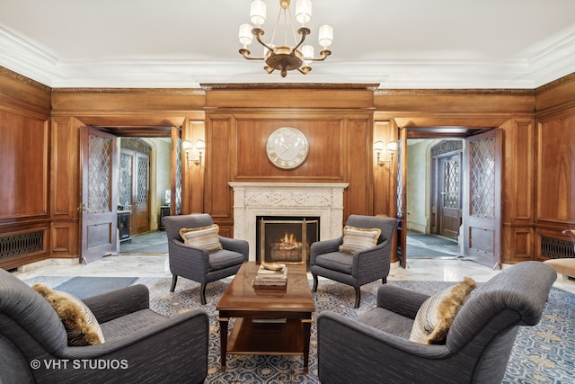 living room with crown molding, a chandelier, and wooden walls