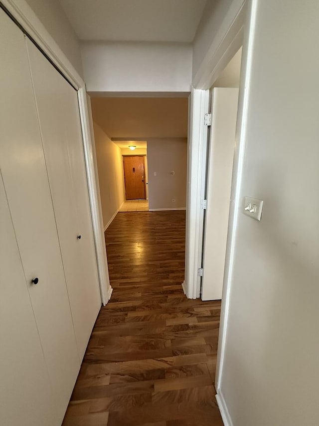 hallway with dark wood-type flooring