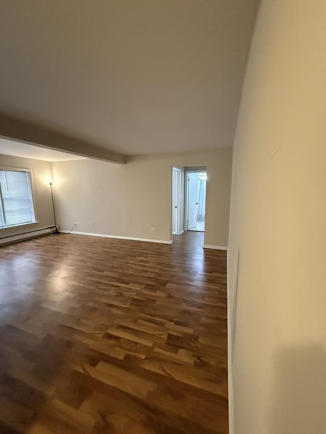 empty room featuring beamed ceiling, a baseboard radiator, and dark wood-type flooring