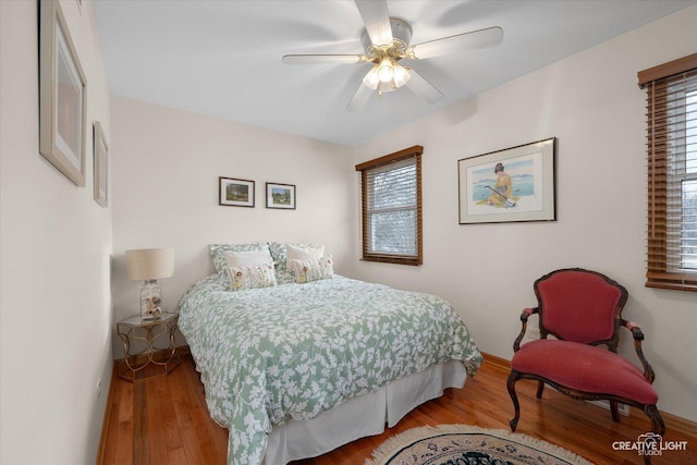 bedroom with ceiling fan and hardwood / wood-style floors